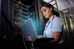 female network administrator working to ensure cybersecurity in her company's manufacturing facility. 